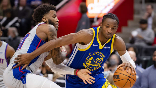 Nov 19, 2021; Detroit, Michigan, USA; Golden State Warriors forward Jonathan Kuminga (00) gets defended by Detroit Pistons forward Saddiq Bey (41) during the second quarter at Little Caesars Arena. Mandatory Credit: Raj Mehta-USA TODAY Sports